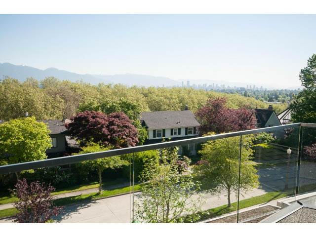 Bright living room with city view and lush greenery. - 3921 West 10th, Vancouver West Side