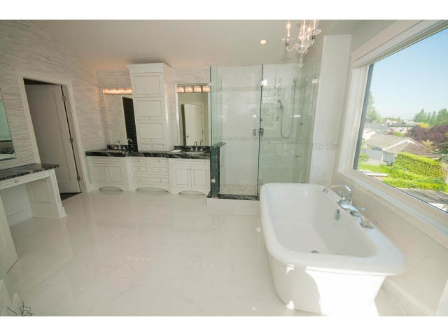 Spacious bathroom with marble countertops, large windows, and a city view. - 3921 West 10th, Vancouver West Side