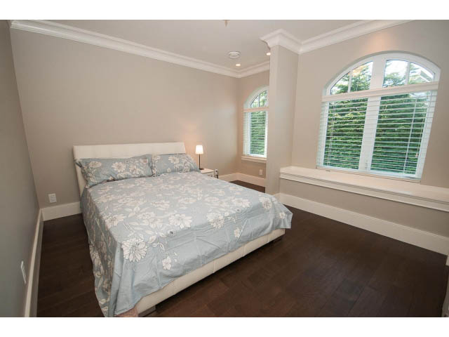 Furnished bedroom with hardwood floors and large arched windows. - 3921 West 10th, Vancouver West Side