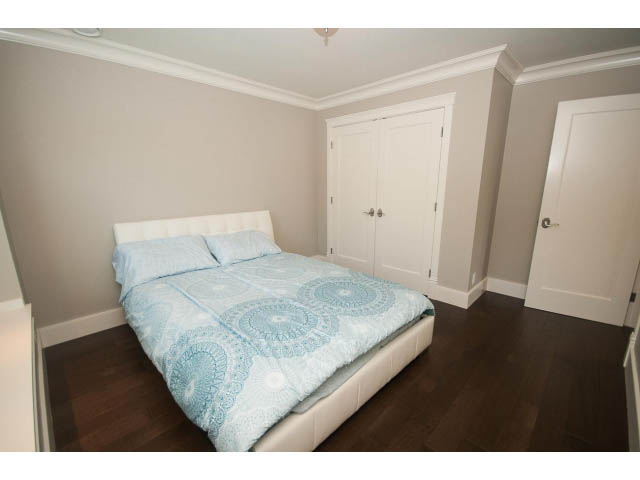 Spacious bedroom with hardwood floors and a neatly made bed. - 3921 West 10th, Vancouver West Side