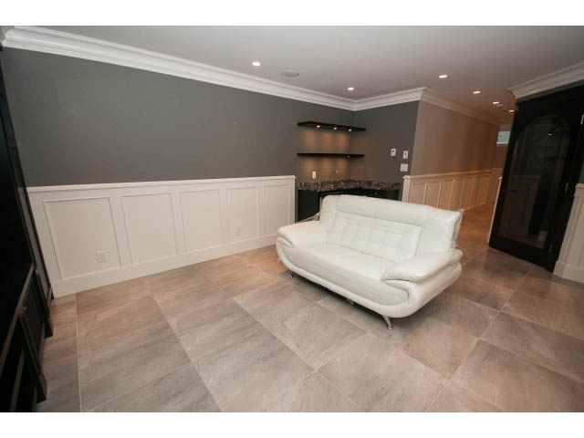 Furnished living room with white walls, tiled floors, and modern furniture. - 3921 West 10th, Vancouver West Side