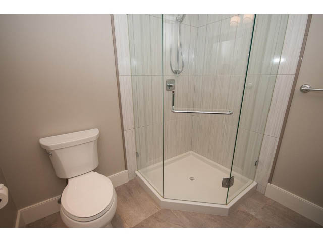 Furnished bathroom with a toilet and a glass-enclosed shower. - 3921 West 10th, Vancouver West Side