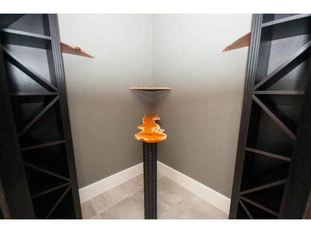 Furniture corner with modern shelving and orange accents. - 3921 West 10th, Vancouver West Side