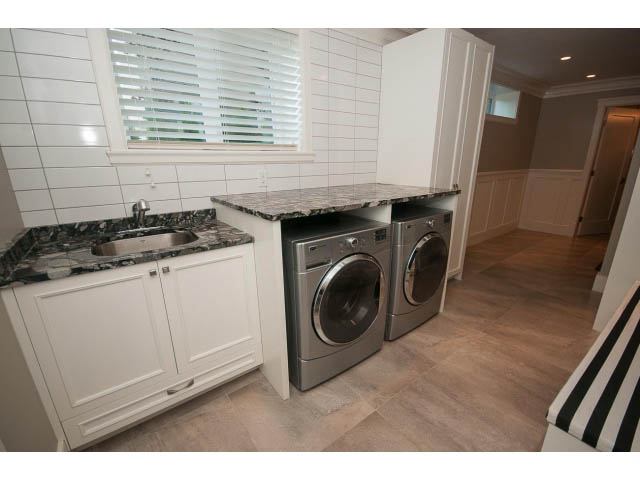 Bright laundry room with granite countertops and hardwood floors. - 3921 West 10th, Vancouver West Side