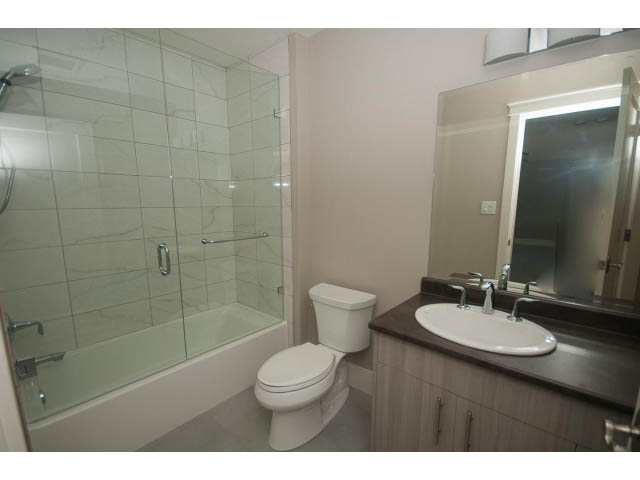 Furnished bathroom with modern sink, countertop, and glass shower. - 3921 West 10th, Vancouver West Side