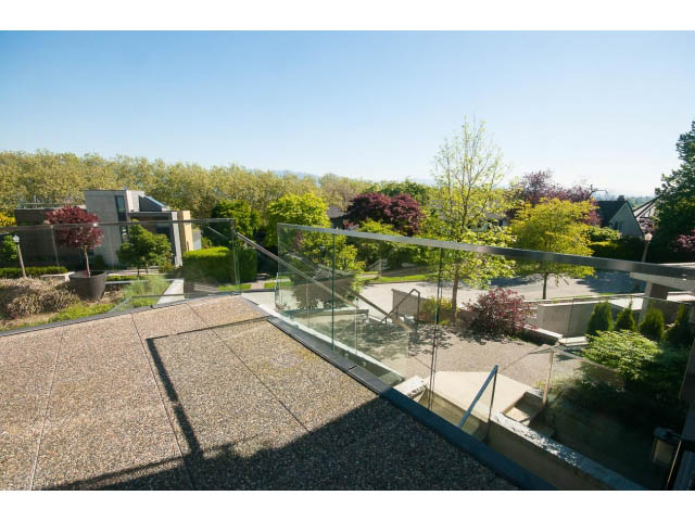 Furnished living room with glass railings and a view of greenery and houses. - 3921 West 10th, Vancouver West Side