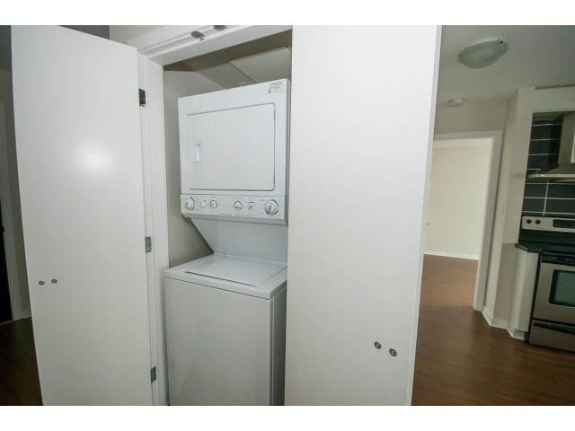 Bright laundry area with white cabinets and countertop, hardwood floors. - 3006 - 188 Keefer Place, Vancouver Downtown
