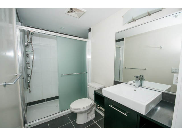 Bright bathroom with white countertops and a glass shower. - 3006 - 188 Keefer Place, Vancouver Downtown