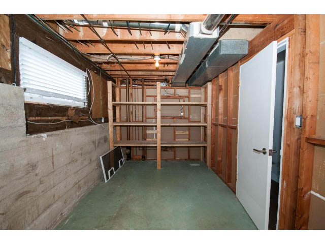 Unfinished basement with exposed beams and ductwork, awaiting renovation. - 3188 St. Andrews Ave, North Vancouver
