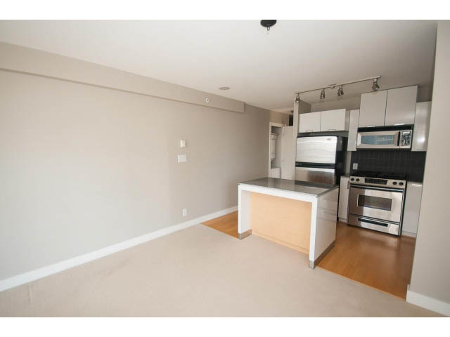Bright kitchen with stainless steel appliances and hardwood floors. - 701 - 151 West 2nd Street, North Vancouver