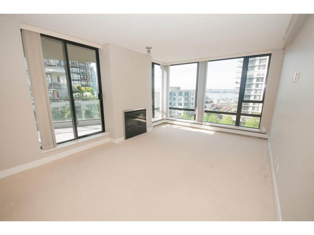 Bright living room with large windows and city view. - 701 - 151 West 2nd Street, North Vancouver