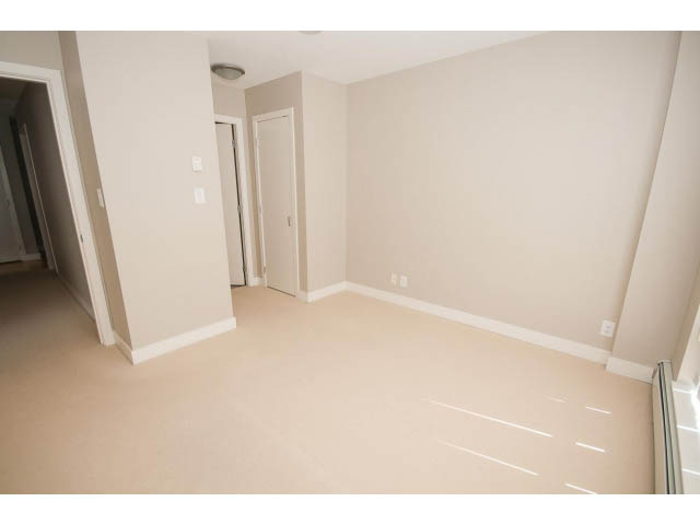 Spacious living room with neutral walls and carpeted floors. - 701 - 151 West 2nd Street, North Vancouver