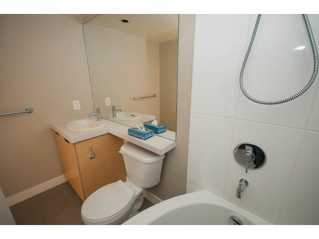 Bathroom with modern sink, toilet, and shower. - 701 - 151 West 2nd Street, North Vancouver