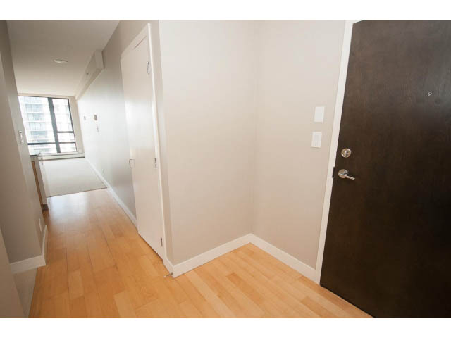 Bright living room with hardwood floors and a city view. - 701 - 151 West 2nd Street, North Vancouver