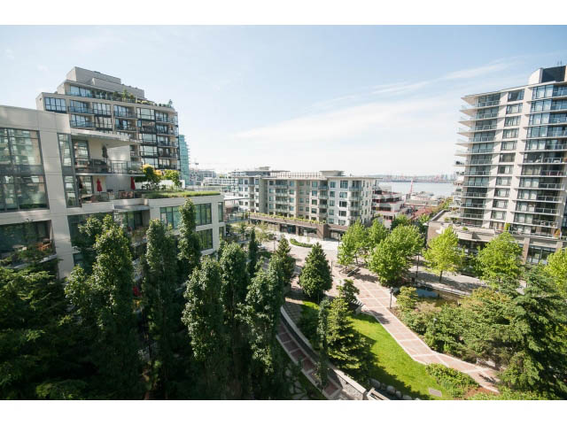 Bright living room with city view and modern furnishings. - 701 - 151 West 2nd Street, North Vancouver