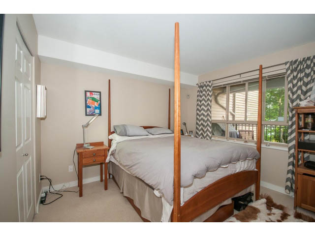 Bright bedroom with bunk beds, desk, and large window view. - 201 - 150 West 22nd Street, North Vancouver