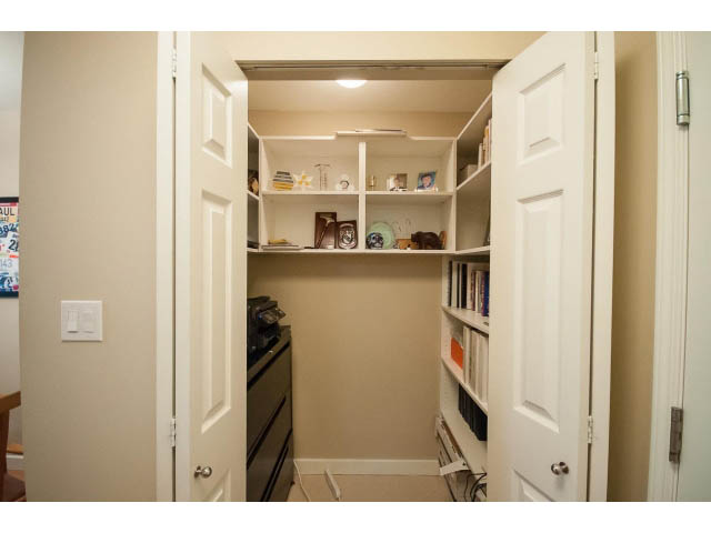 Furnished walk-in closet with built-in shelves and storage. - 201 - 150 West 22nd Street, North Vancouver