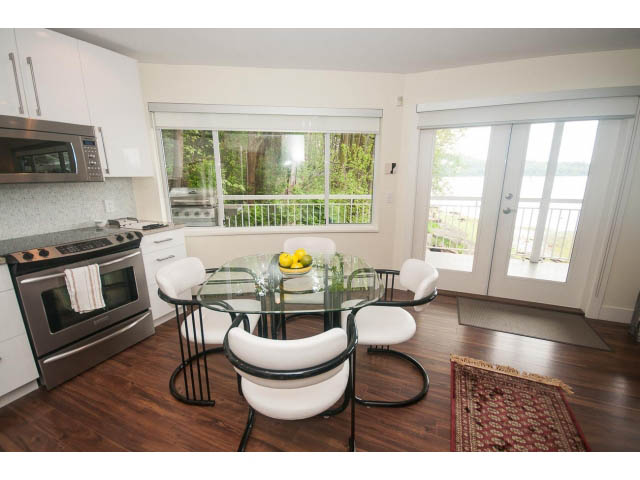 Bright kitchen with hardwood floors, city view, and modern furnishings. - Suite - 2985 Dollarton Hwy, North Vancouver