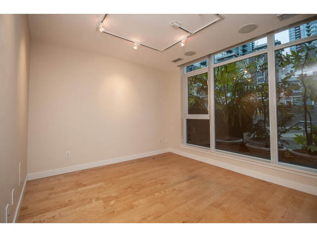 Bright living room with hardwood floors and large windows offering a city view. - TH17 - 1233 West Cordova St, Vancouver Downtown