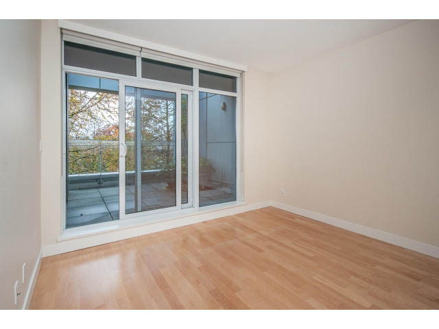 Bright living room with hardwood floors and large sliding glass doors leading to a balcony. - TH17 - 1233 West Cordova St, Vancouver Downtown