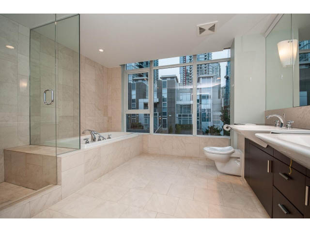 Spacious bathroom with large windows, city view, and modern fixtures. - TH17 - 1233 West Cordova St, Vancouver Downtown