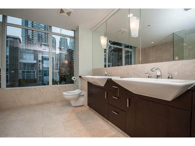 Modern bathroom with large mirror, city view, and sleek countertop. - TH17 - 1233 West Cordova St, Vancouver Downtown