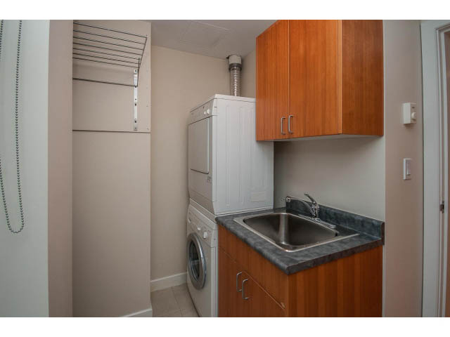 Bright laundry room with wooden cabinets and granite countertops. - TH17 - 1233 West Cordova St, Vancouver Downtown