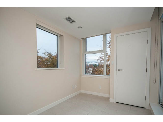 Bright den with large windows offering a city view, light-colored walls, and a white door. - TH17 - 1233 West Cordova St, Vancouver Downtown