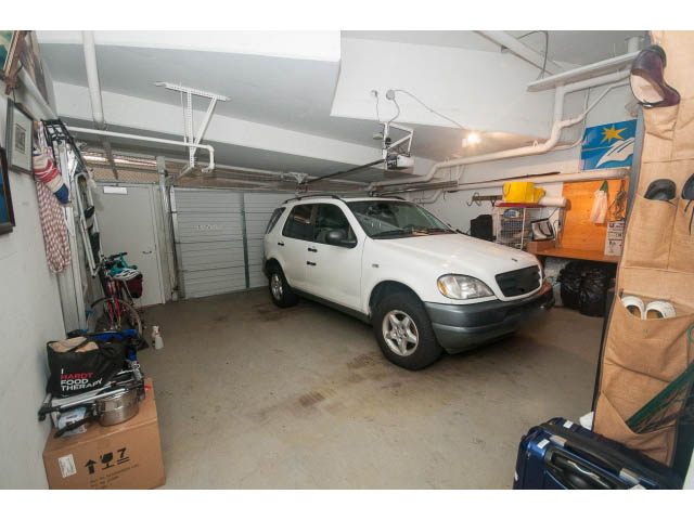Garage with white SUV, storage shelves, and tools. - TH17 - 1233 West Cordova St, Vancouver Downtown