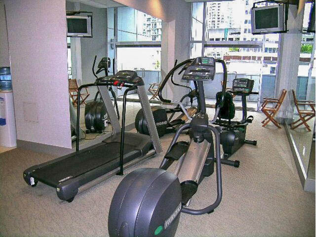 Bright fitness room with treadmills and city view. - TH17 - 1233 West Cordova St, Vancouver Downtown