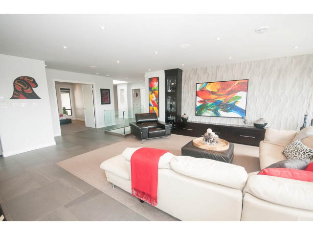 Spacious living room with modern decor, large artwork, and comfortable seating. - 2948 Marykirk Place, North Vancouver