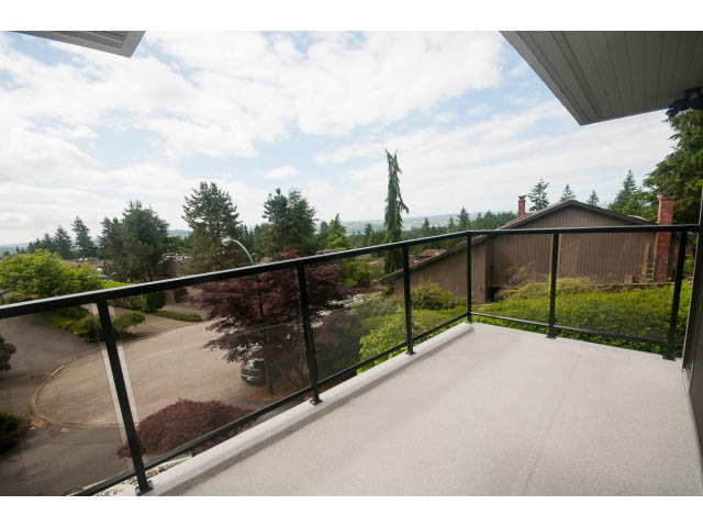 Balcony with city view and lush greenery. - 2948 Marykirk Place, North Vancouver
