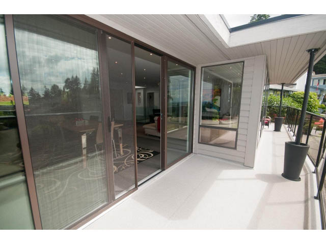 Furnished balcony with sliding glass doors, city view, and modern decor. - 2948 Marykirk Place, North Vancouver