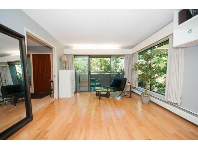 Bright living room with hardwood floors, large windows, and city view. - 5338 Montiverdi Pl, West Vancouver