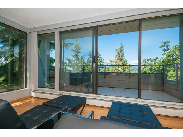 Bright living room with large windows, hardwood floors, and a city view. - 5338 Montiverdi Pl, West Vancouver
