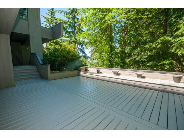 Spacious deck with wooden flooring and lush greenery. - 5338 Montiverdi Pl, West Vancouver