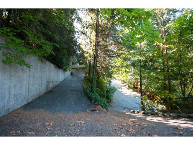 Fenced backyard with concrete walls and lush greenery. - 5338 Montiverdi Pl, West Vancouver