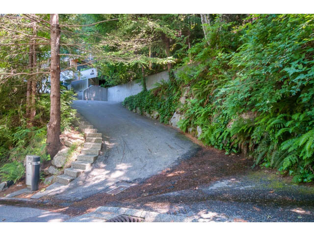 Staircase leading to a house with lush greenery and a concrete wall. - 5338 Montiverdi Pl, West Vancouver