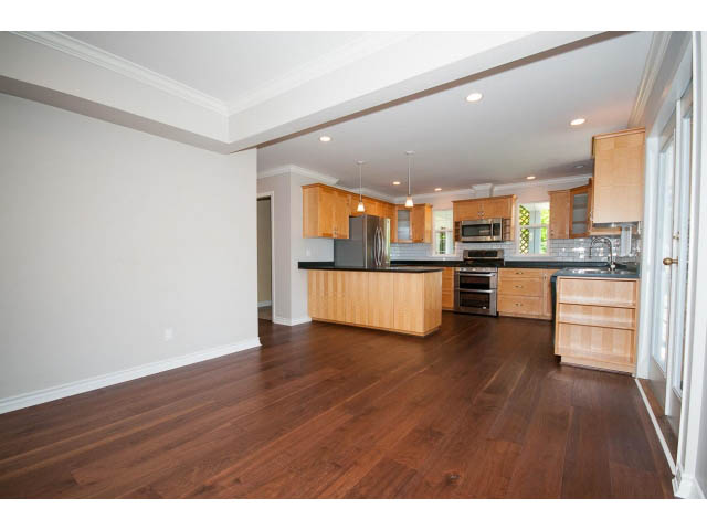 Bright kitchen with hardwood floors, modern appliances, and ample counter space. - 3626 Loraine Ave, North Vancouver
