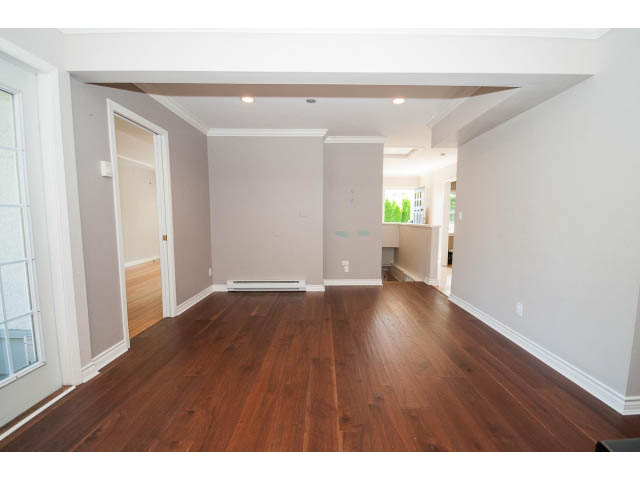 Spacious living room with hardwood floors and large windows. - 3626 Loraine Ave, North Vancouver