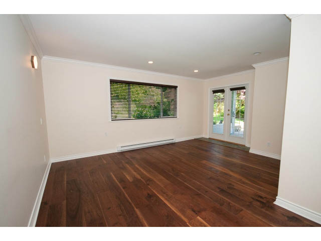 Spacious living room with hardwood floors and large windows. - 3626 Loraine Ave, North Vancouver