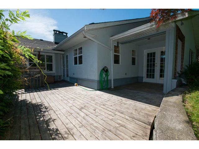 Furnished living room with hardwood floors and a cozy deck. - 3626 Loraine Ave, North Vancouver