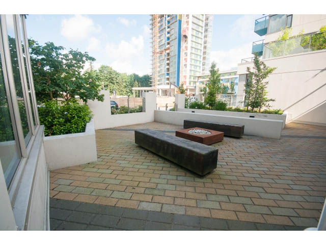 Furnished patio with modern seating and greenery, city view in background. - 1504-1550 Fern Street, North Vancouver