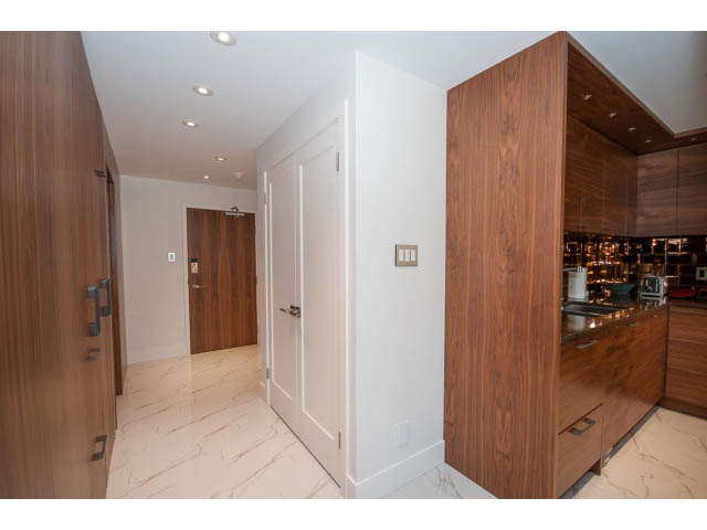 Bright kitchen with marble countertops and wood cabinetry. - 307 - 1490 Pennyfarthing Drive, Vancouver West Side