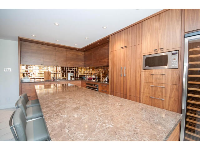 Bright kitchen with granite countertops, wooden cabinets, and stainless steel appliances. - 307 - 1490 Pennyfarthing Drive, Vancouver West Side