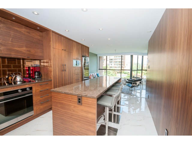 Bright kitchen with modern appliances, granite countertops, and a city view. - 307 - 1490 Pennyfarthing Drive, Vancouver West Side