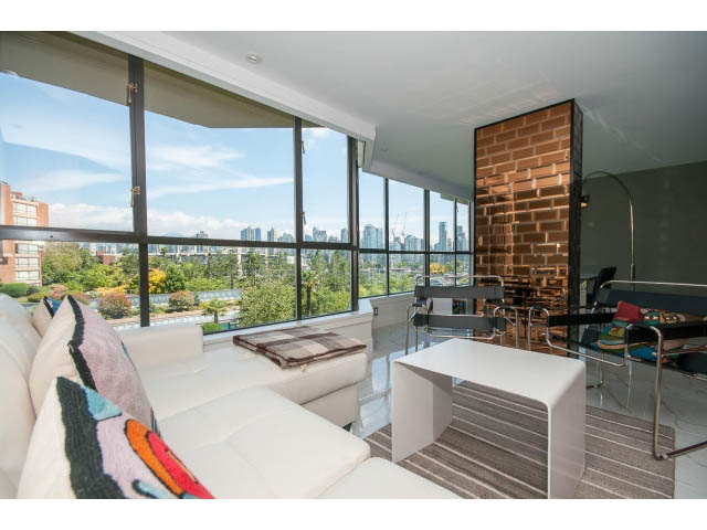 Bright living room with city view, modern furnishings, and large windows. - 307 - 1490 Pennyfarthing Drive, Vancouver West Side