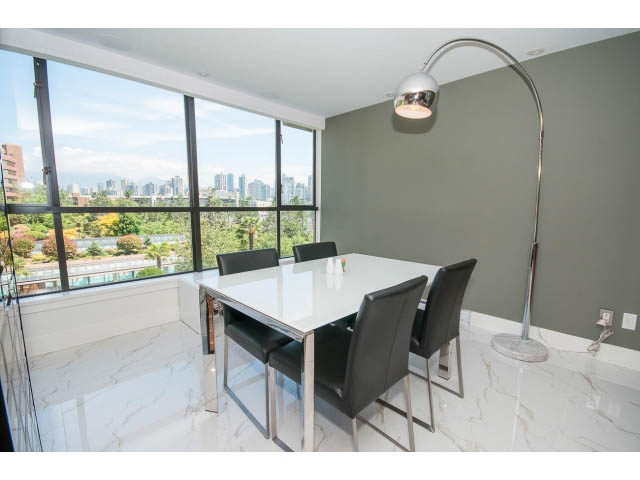 Bright dining area with city view and modern furniture. - 307 - 1490 Pennyfarthing Drive, Vancouver West Side