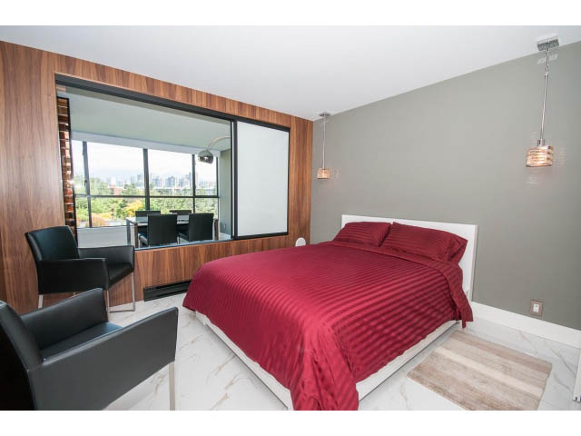Spacious bedroom with large window, city view, and modern furnishings. - 307 - 1490 Pennyfarthing Drive, Vancouver West Side