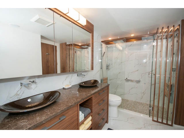 Furnished bathroom with marble countertops and a glass-enclosed shower. - 307 - 1490 Pennyfarthing Drive, Vancouver West Side
